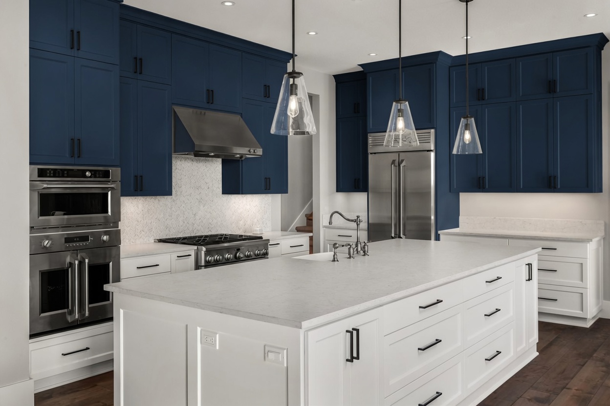 Same kitchen — blue upper cabinets, white lowers